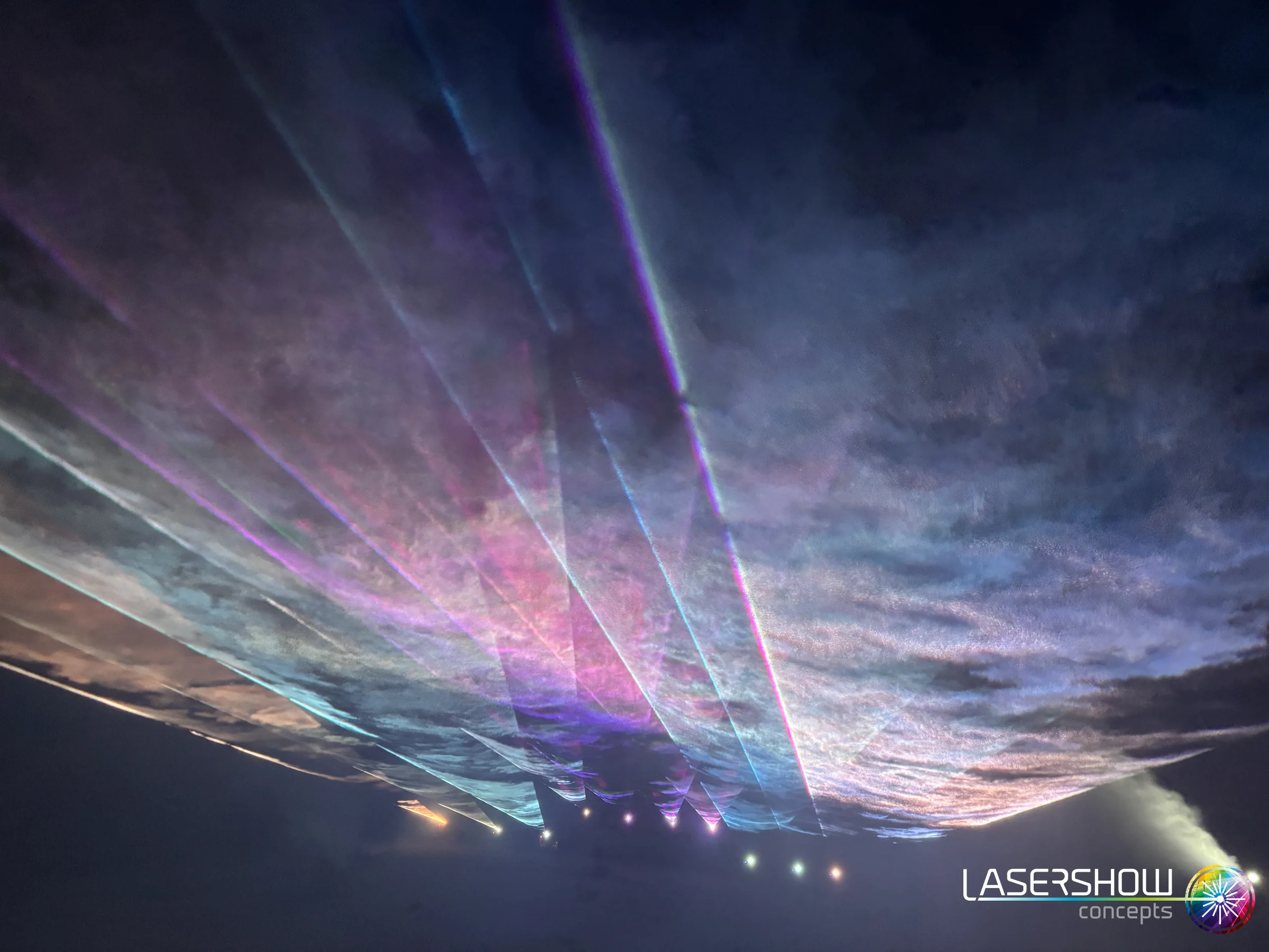 Laserfächer durch Wolken und Nebel bei einer Silvester-Lasershow